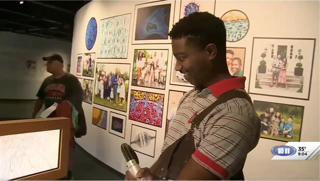 Luminarium team member Quentin smiles while engaging with the Self Scope exhibit.